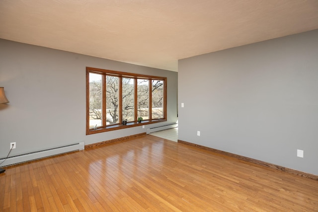 809 60th Ave SW, Rochester, MN 55902 - unfurnished room featuring a baseboard radiator, light wood-style flooring, and baseboards
