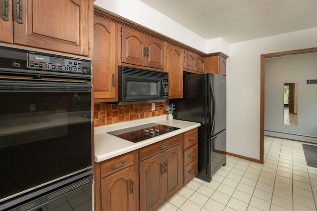 809 60th Ave SW, Rochester, MN 55902 - kitchen with black appliances, baseboard heating, tasteful backsplash, light tile patterned floors, and light countertops