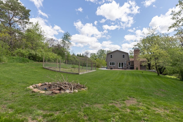 809 60th Ave SW, Rochester, MN 55902 - view of green lawn featuring an outdoor fire pit and a patio