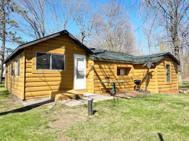 20455 326th Ave, Isle, MN 56342 - back of property with a yard, a shingled roof, and faux log siding