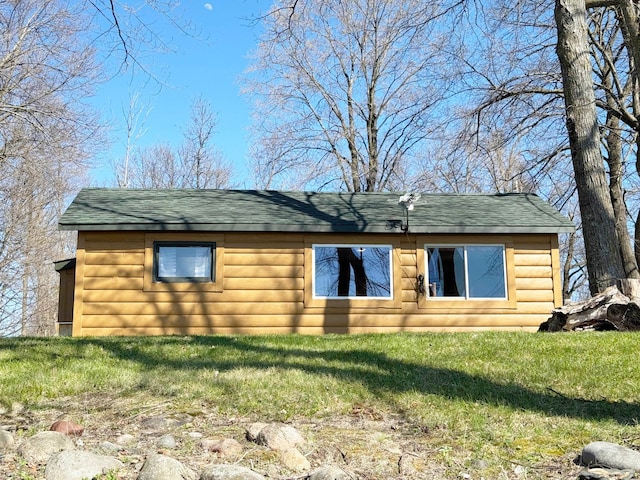 20455 326th Ave, Isle, MN 56342 - view of side of home with a lawn, faux log siding, and roof with shingles