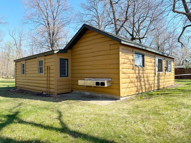 20455 326th Ave, Isle, MN 56342 - view of home's exterior featuring a yard, faux log siding, and fence