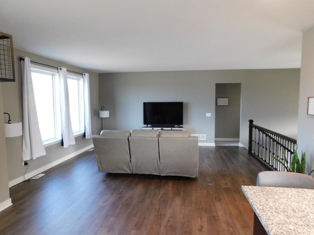 living room with baseboards and dark wood-style flooring