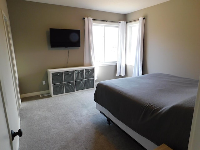 bedroom featuring baseboards and carpet floors