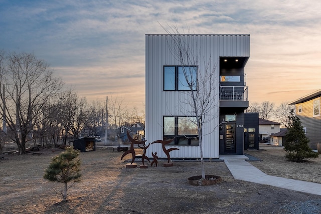 view of front of house with a balcony and board and batten siding