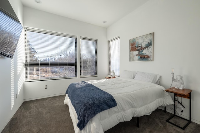 carpeted bedroom featuring baseboards