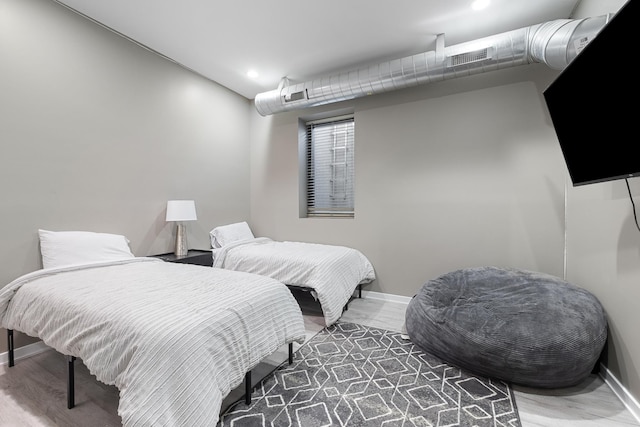 bedroom featuring recessed lighting, visible vents, baseboards, and wood finished floors