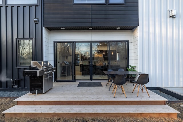 doorway to property featuring outdoor dining space and a wooden deck