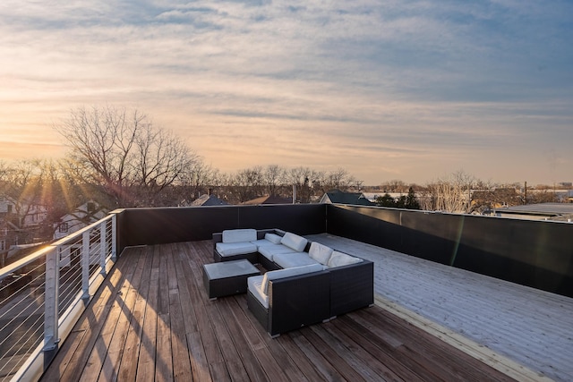 deck at dusk with an outdoor living space