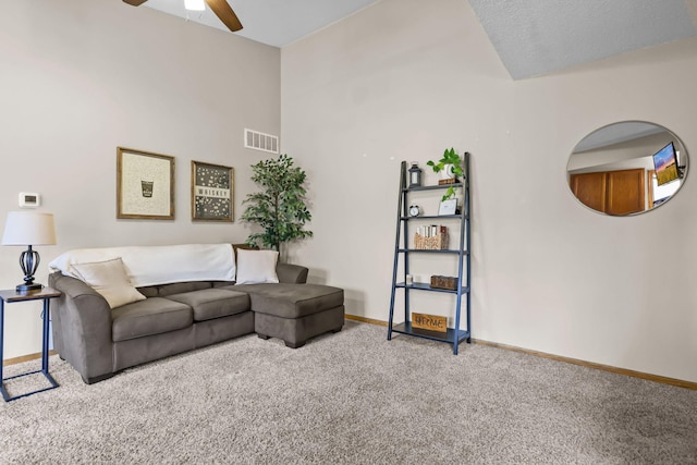 carpeted living area with visible vents, a ceiling fan, and baseboards