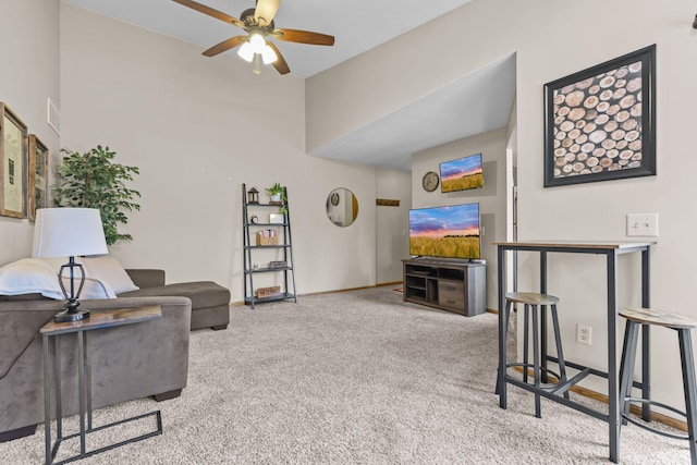 carpeted living room featuring visible vents, a ceiling fan, and baseboards