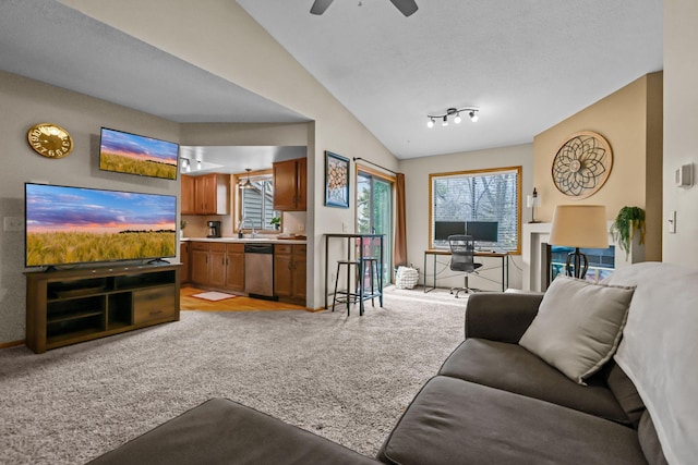 living area with light carpet, lofted ceiling, and ceiling fan