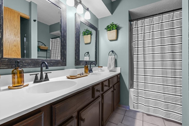 bathroom featuring a sink, shower / bath combination with curtain, double vanity, and tile patterned flooring