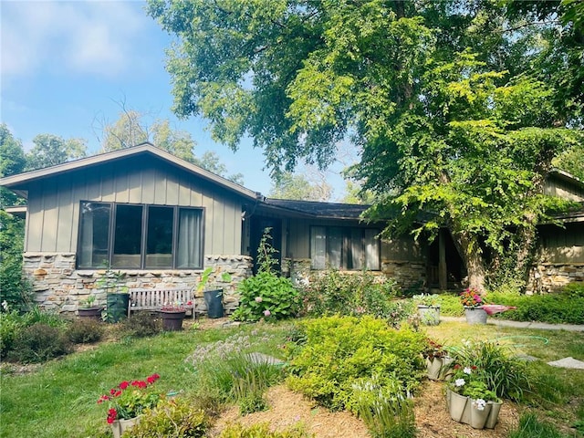 view of front of home with stone siding and board and batten siding