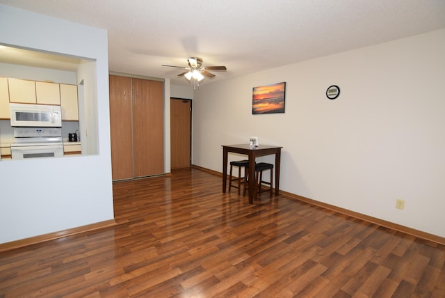 kitchen with wood finished floors, white appliances, light countertops, baseboards, and ceiling fan