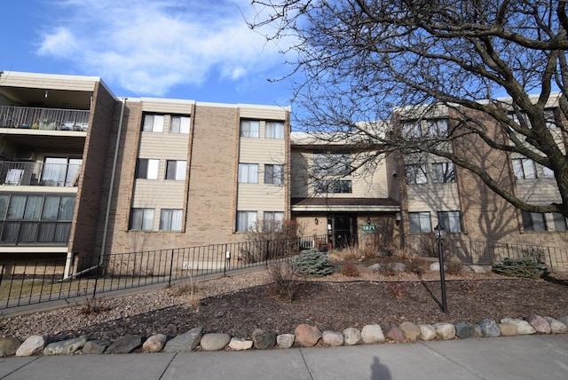 view of building exterior with fence