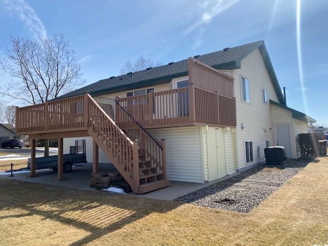 back of house featuring a yard, stairway, a patio, and a deck