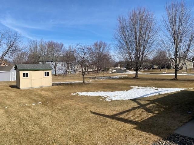 view of yard with an outbuilding and a shed