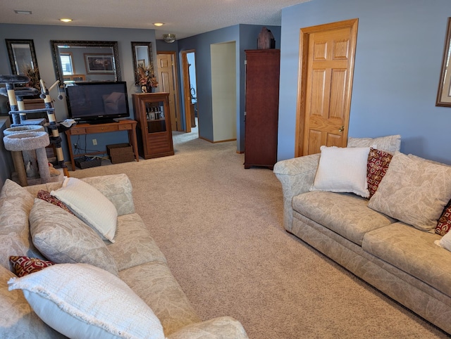 living area featuring carpet flooring, recessed lighting, and baseboards