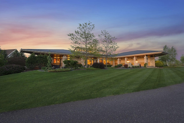 view of front of house featuring a front yard and metal roof