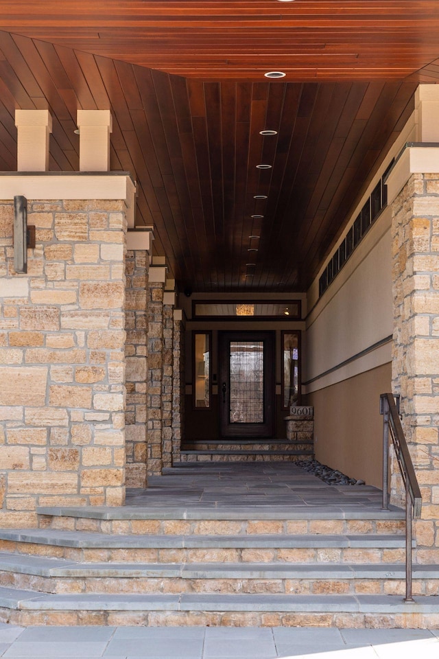 property entrance featuring stone siding