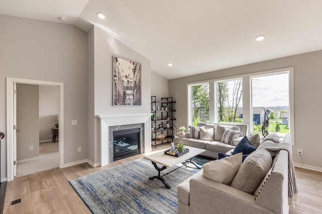 9176 62nd St S, Cottage Grove, MN 55016 - living area with light wood finished floors, vaulted ceiling, recessed lighting, and a fireplace