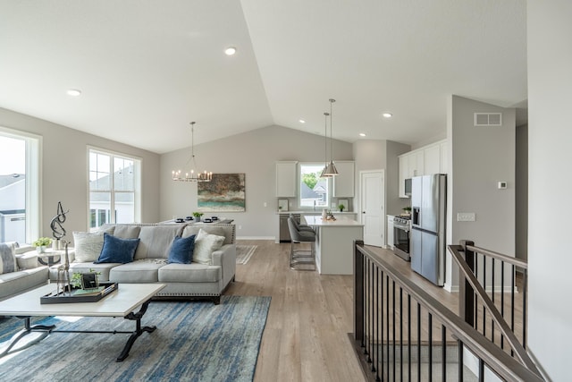 9176 62nd St S, Cottage Grove, MN 55016 - living room featuring lofted ceiling, light wood finished floors, a chandelier, and recessed lighting