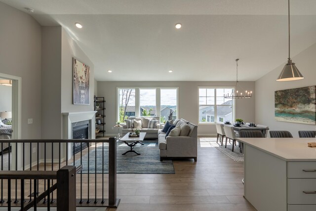 9176 62nd St S, Cottage Grove, MN 55016 - living area featuring a chandelier, dark wood-type flooring, a fireplace, recessed lighting, and lofted ceiling
