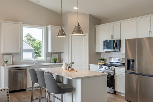 9176 62nd St S, Cottage Grove, MN 55016 - kitchen with stainless steel appliances, tasteful backsplash, a center island, light countertops, and recessed lighting