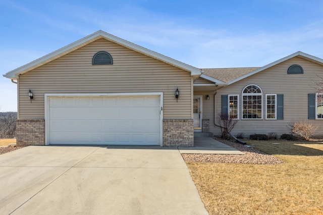 ranch-style house with a front lawn, brick siding, concrete driveway, and an attached garage