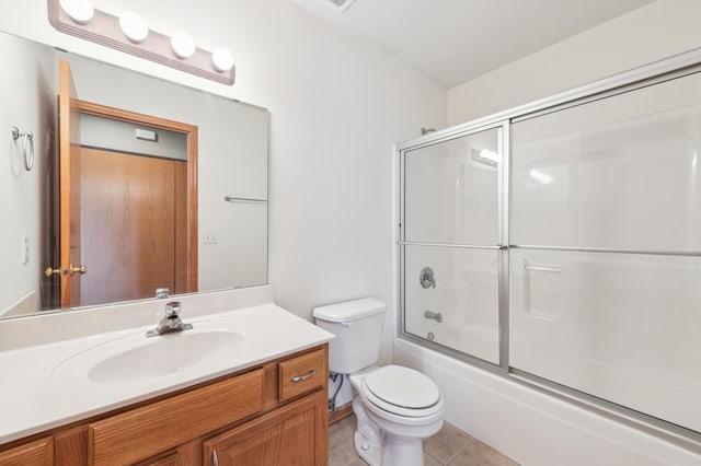 full bath with tile patterned floors, enclosed tub / shower combo, toilet, and vanity