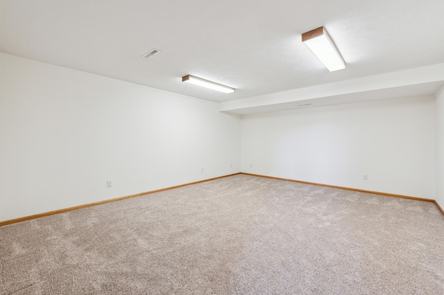 carpeted empty room with baseboards