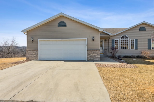 ranch-style house with concrete driveway, an attached garage, brick siding, and a front lawn