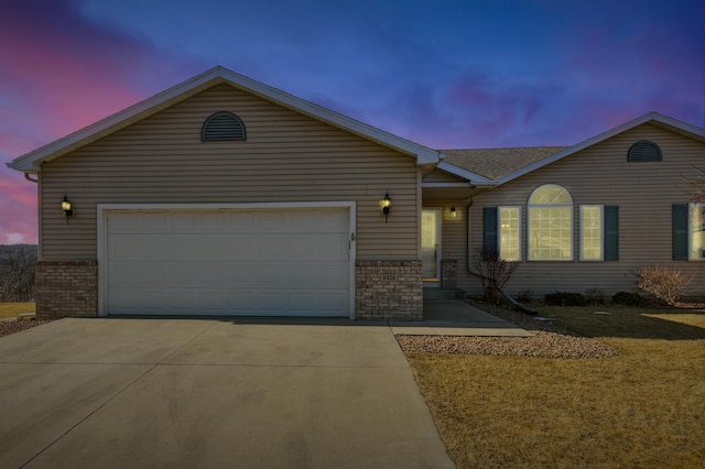 single story home with brick siding, an attached garage, driveway, and a front lawn