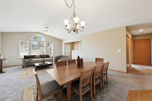 dining space featuring baseboards, lofted ceiling, and carpet floors