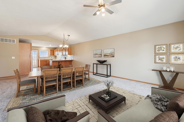 living area with visible vents, baseboards, light colored carpet, lofted ceiling, and ceiling fan with notable chandelier