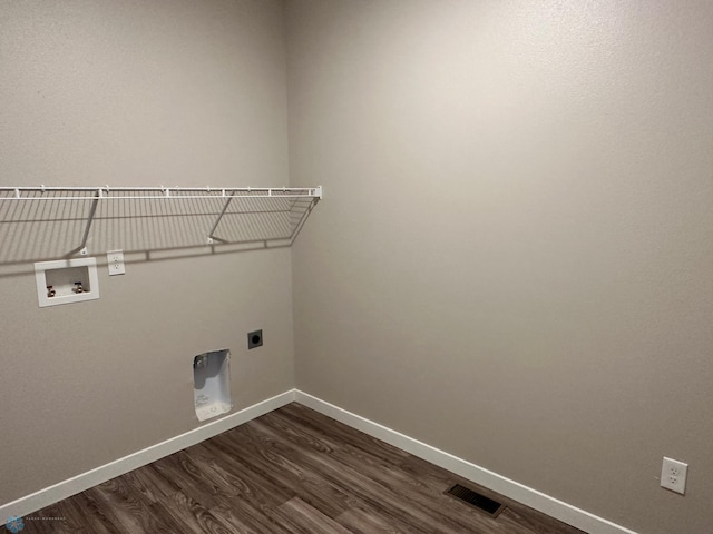 laundry room featuring dark wood-style floors, baseboards, visible vents, hookup for an electric dryer, and laundry area