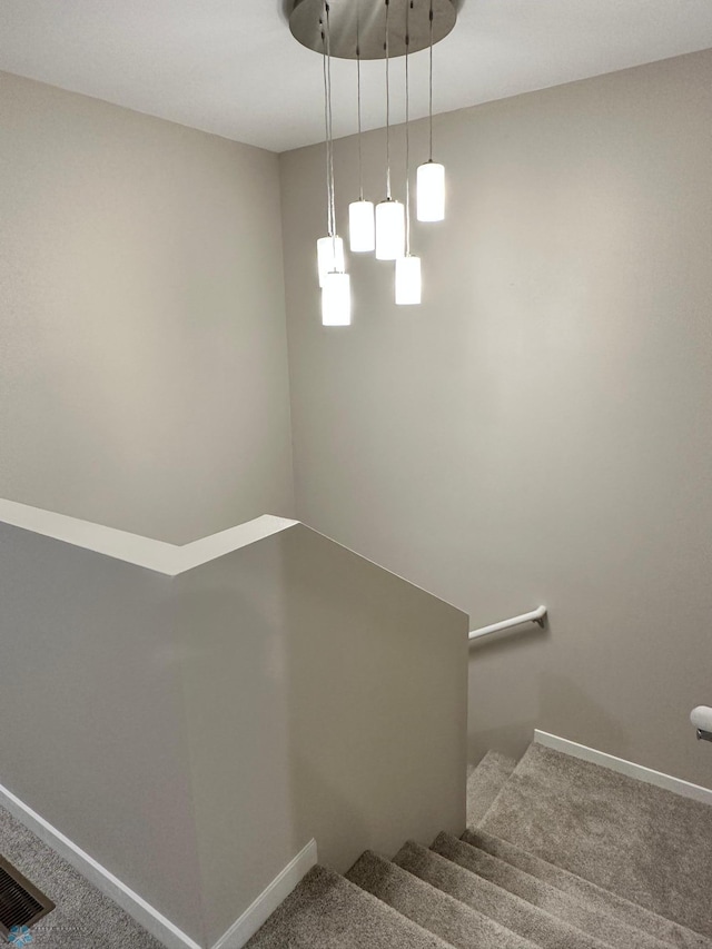 staircase featuring carpet flooring, baseboards, and visible vents