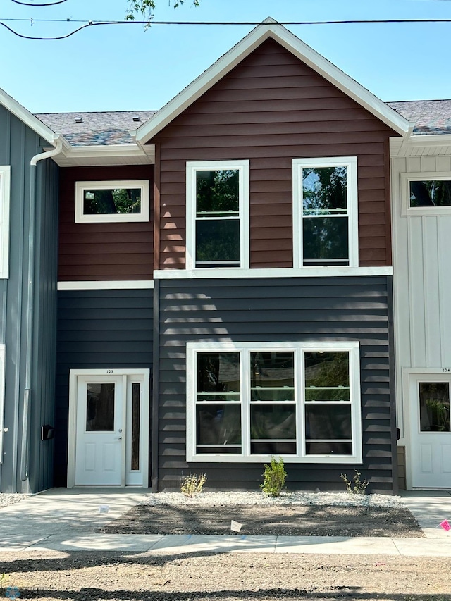 view of front facade featuring board and batten siding and a shingled roof