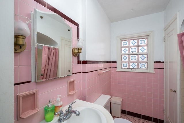 bathroom with curtained shower, toilet, and tile walls