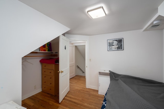 bedroom with light wood-style flooring, baseboards, and visible vents