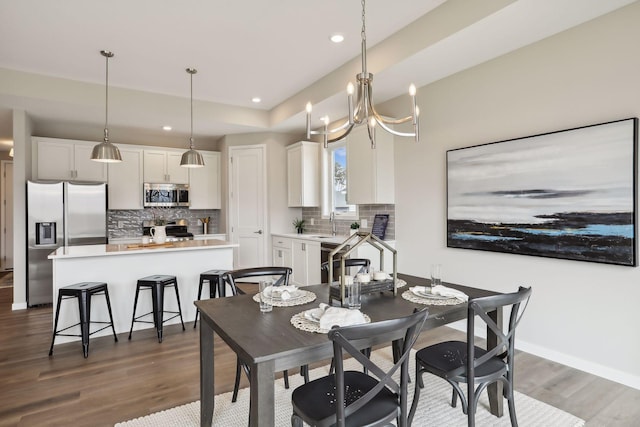 9184 62nd St S, Cottage Grove, MN 55016 - dining space featuring wood finished floors, recessed lighting, and a chandelier