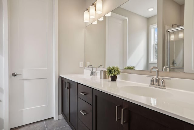 9184 62nd St S, Cottage Grove, MN 55016 - bathroom featuring double vanity, tile patterned floors, and a shower with shower door