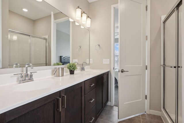9184 62nd St S, Cottage Grove, MN 55016 - ensuite bathroom featuring double vanity, a stall shower, and tile patterned flooring