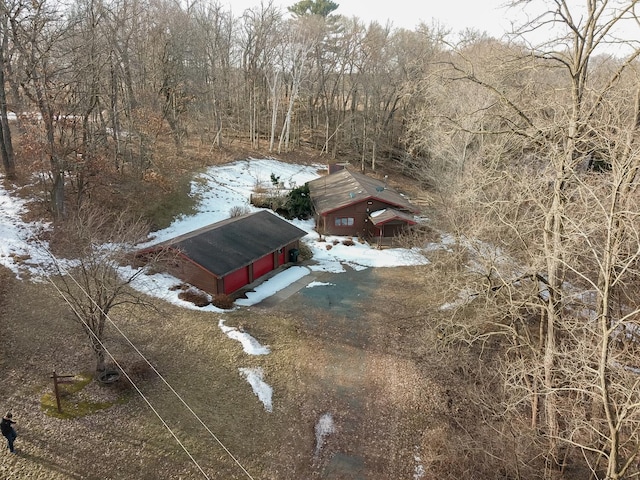 snowy aerial view featuring a view of trees