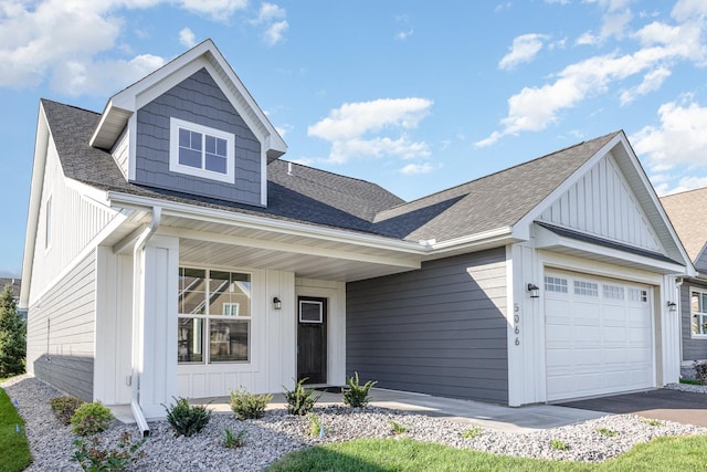 view of front facade featuring a porch, an attached garage, board and batten siding, and roof with shingles