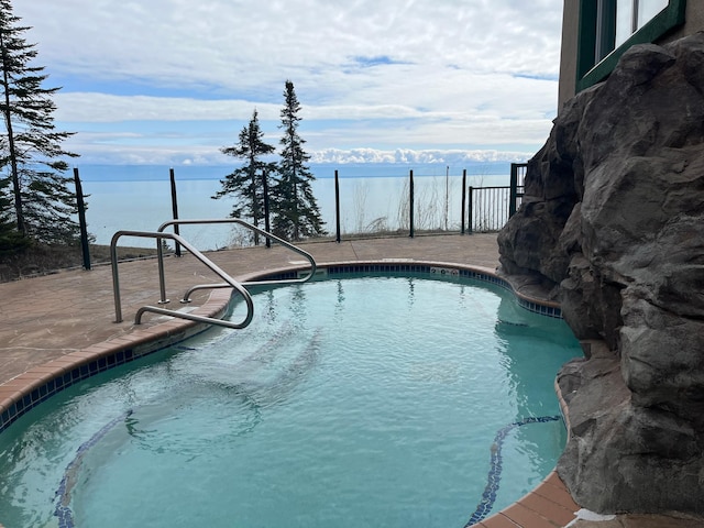 view of swimming pool featuring a fenced in pool and a patio