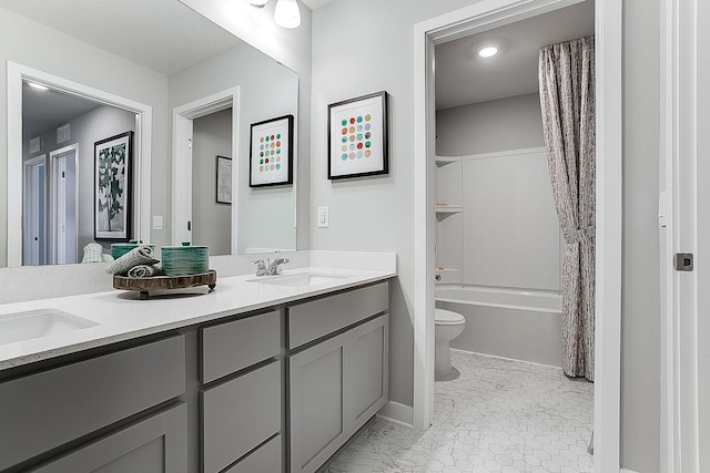 bathroom featuring double vanity, a sink, shower / tub combo with curtain, and toilet
