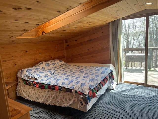 bedroom featuring wooden walls, wood ceiling, carpet floors, and access to outside