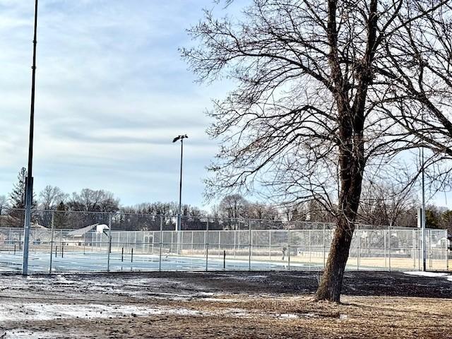 view of tennis court with fence